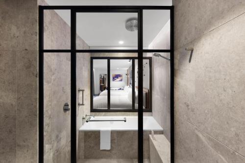 墨尔本Le Méridien Melbourne的一间带水槽和镜子的浴室