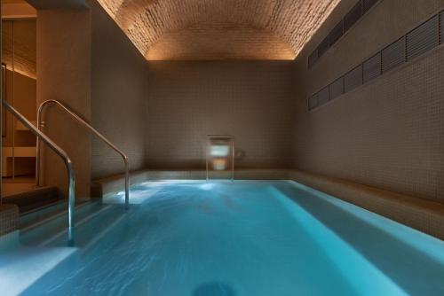 加的斯Áurea Casa Palacio Sagasta by Eurostars Hotel Company的一个带天花板的房间的大型游泳池