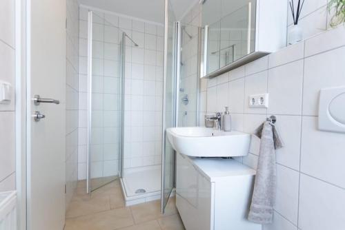 阿赫恩City-House-Achern的白色的浴室设有水槽和淋浴。
