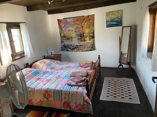 BebrovoLavender and Poppy cottages的卧室配有一张床,墙上挂有绘画作品