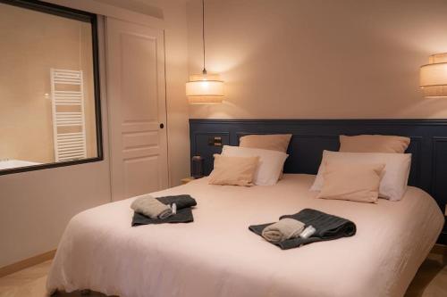 科洛布里埃Suite de Luxe Jacuzzi balnéo,King size Bed的一间卧室配有一张床,上面有两条毛巾