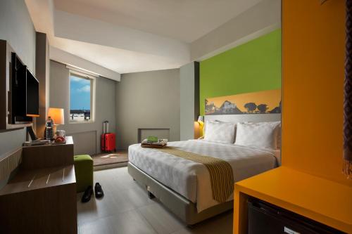 日惹KHAS Malioboro Hotel的酒店客房,设有床铺和绿色的墙壁