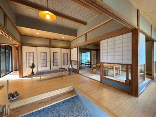 萩市shukubo michiru 満行寺的大型客房,设有木地板和窗户。
