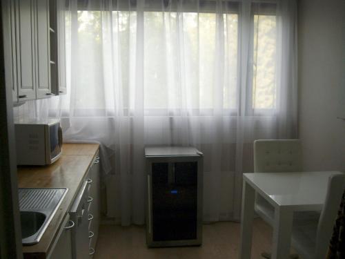 Kauniainen21 minutes from Helsinki city - larger room的厨房配有带白色窗帘的窗户