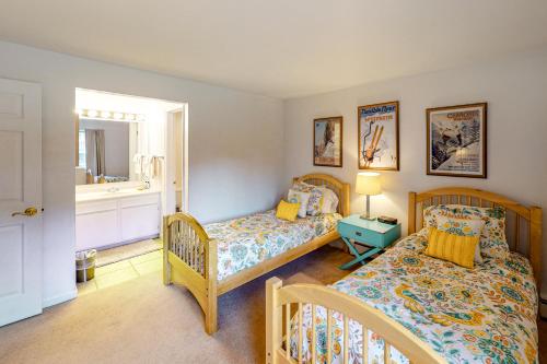 斯诺马斯村Snowmass Village 14A的一间卧室配有两张床和镜子