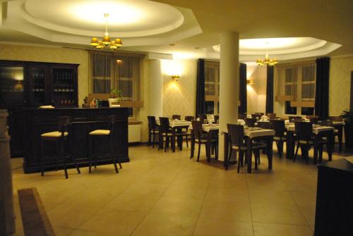 琴斯托霍瓦Zielony Dworek的餐厅内带桌椅的用餐室