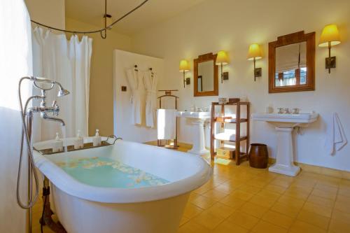 大叻Ana Mandara Villas Dalat Resort & Spa的带浴缸和两个盥洗盆的大浴室