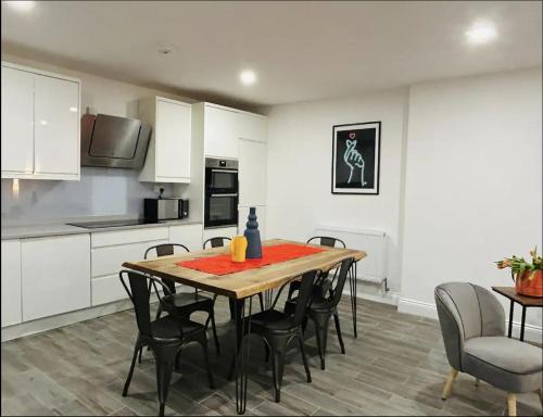 伦敦Gorgeous split level Belsize Park Apartment的厨房以及带桌椅的用餐室。