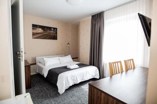希奥利艾托马斯酒店的配有一张床和一张书桌的酒店客房