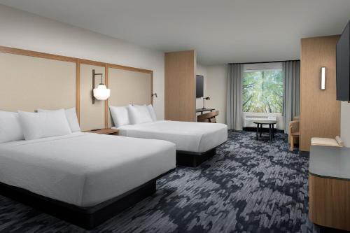阿普尔顿Fairfield Inn & Suites by Marriott Appleton的酒店客房配有两张床和一张书桌
