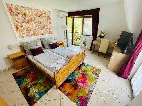 凯斯特海伊Villa Peonia的卧室配有一张位于色彩缤纷的地毯上的床铺