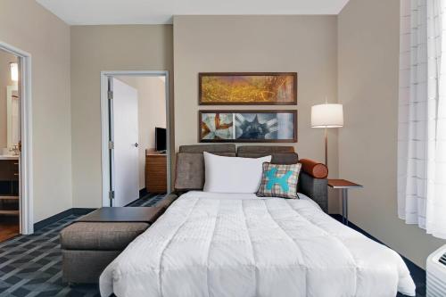 印第安纳波利斯TownePlace Suites by Marriott Indianapolis Downtown的一间卧室配有一张大床和一盏灯