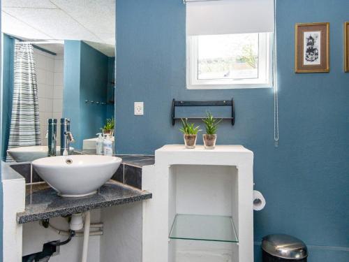 海耶斯Holiday home Hejls LIII的浴室设有白色水槽和蓝色的墙壁