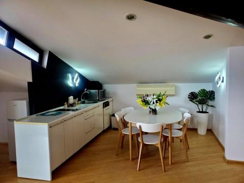 苏利纳Cirex Delta Club Sulina的厨房配有白色的桌椅和柜台。