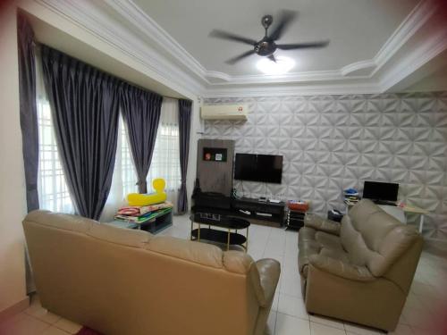 马西Happy Home [Bandar Seri Alam]的客厅配有2张沙发和1台平面电视