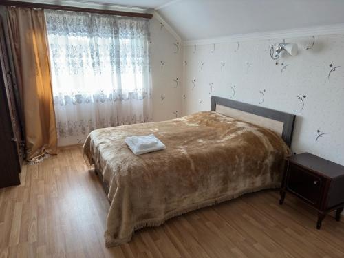 塞凡Chkalovka guest house with Sevan view的一间卧室设有一张大床和一个窗户。