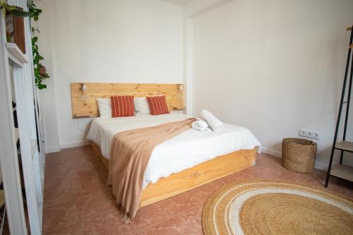 马希库The Village House的一间卧室配有一张大床和木制床头板