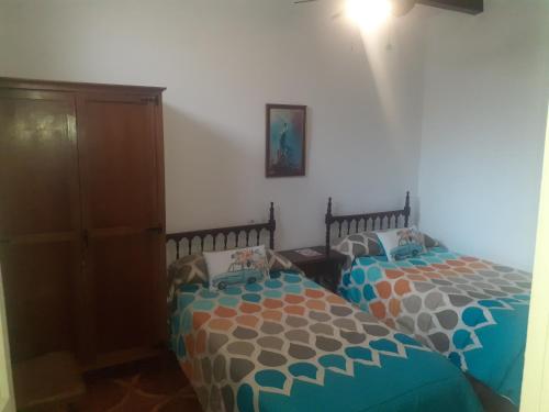 乌贝达Casa Manuel的一间卧室设有两张单人床和一个橱柜