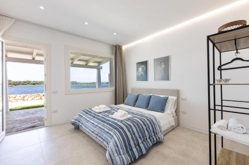 奥尔比亚Baia del Sole的一间卧室配有一张床,享有水景
