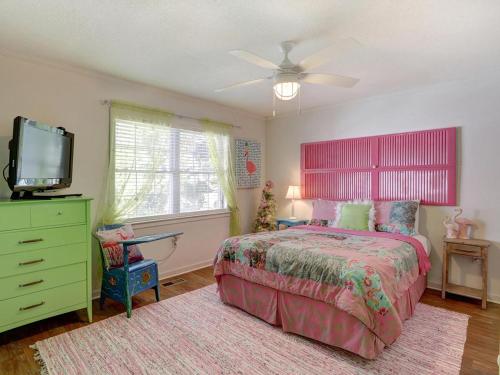 泰比岛Barefoot Children的一间卧室配有一张床和一台平面电视