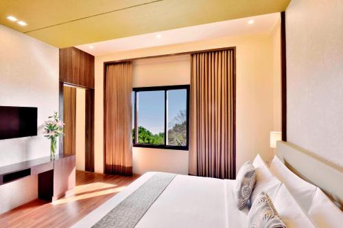 斯利那加斯利那加福朋喜来登酒店的酒店客房设有床和窗户。
