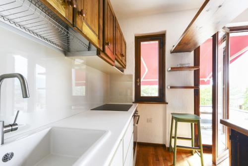 Sueglioil larice d' oro的白色的厨房设有水槽和窗户