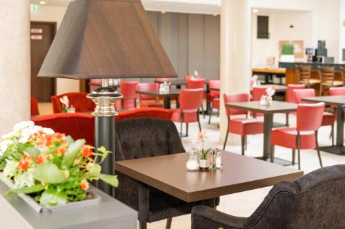 美因河畔法兰克福Hotel Schopenhauer Hof的用餐室配有桌椅和台灯