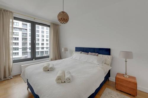 格丁尼亚Apartament w Gdyni - Plac Unii by Grand Apartments的一间卧室配有一张大床,上面有白色毛巾