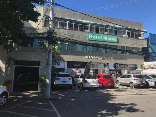 萨尔瓦多Hotel Minas Salvador的停车场内有车辆的建筑物