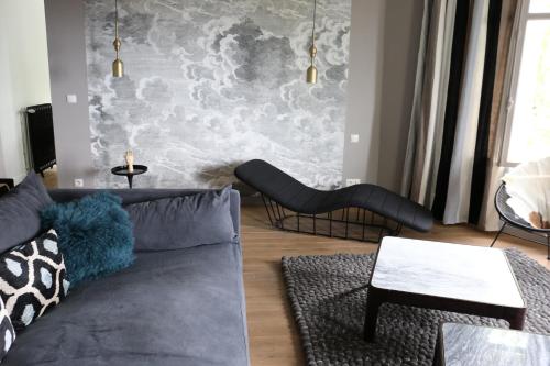 勒阿弗尔Maison Valmer - L'armateur, élégant penthouse classé 4 étoiles的带沙发和壁画的客厅