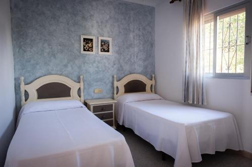 科尼尔-德拉弗龙特拉图里斯提克斯卡波罗施公寓酒店的带窗户的客房内的两张床