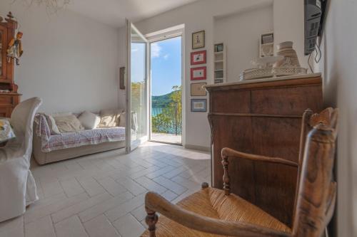 Colle di ToraLetizia lake house panoramic view的一间带椅子和床的房间以及窗户