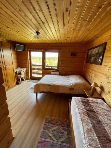DanielkyAgroturystyka Pod Gronikami pokoje的小木屋内一间卧室,配有两张床