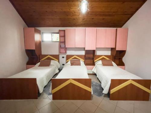 地拉那Vila Kodra的一间房间,有三张床