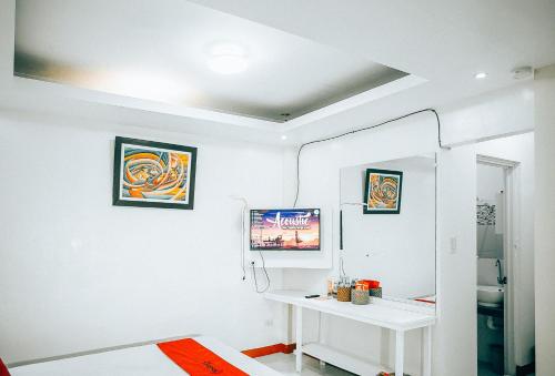 黎牙实比RedDoorz S&L Apartelle Daraga Albay的白色的客房配有白色的桌子和镜子
