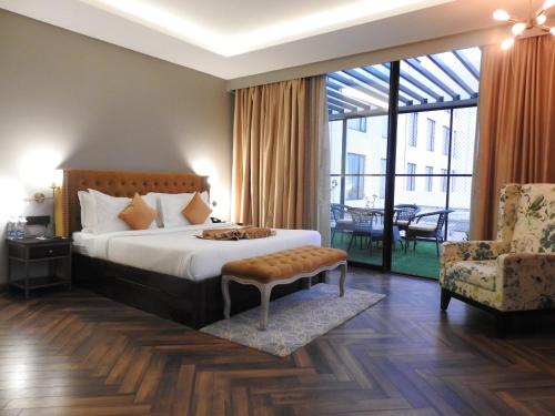 阿加尔塔拉Hotel Polo Towers Agartala的卧室配有床、椅子和窗户。