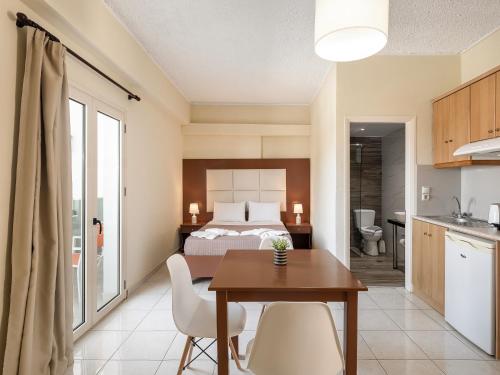 卡拉马基索非亚公寓酒店的卧室配有一张床和一张桌子及椅子