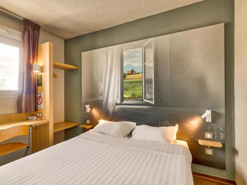 奥比埃B&B HOTEL Clermont-Ferrand Sud Aubière的一间卧室设有一张大床和一个窗户。