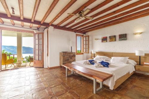 福尔内利斯Villa de lujo en Playa de Fornells的一间卧室设有一张大床和木制天花板