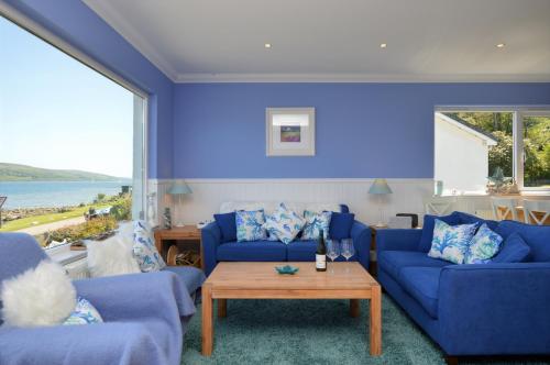 KamesCraignethan的蓝色的客厅配有两张蓝色的沙发和一张桌子