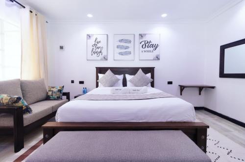 纳纽基Arabel's Place Riverside Villas的一间卧室配有一张大床和一张沙发