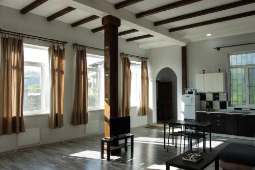 苏呼米Casa-Colina 2 вид на горы и море的客厅配有桌椅和窗户。