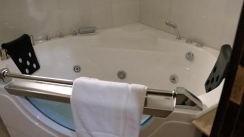 阿布贾Nisa Wellness Retreat的带浴缸的浴室和毛巾