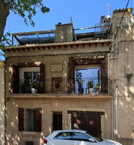 马赛Studio indépendant dans maison de ville, au calme的停车场位于带阳台的大楼前