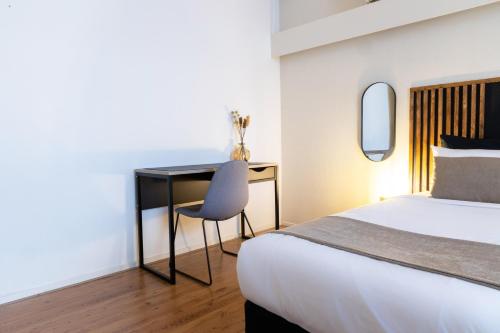 阿姆斯特丹佛兰肯代尔公寓酒店的一间卧室配有一张床和一张桌子及椅子
