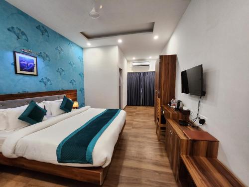 巴特那Hotel Golden Palm的一间卧室配有一张大床和电视