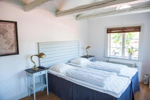 南雪平Johannas GuestHouse的一间卧室配有一张大床和一张桌子上的两盏灯。