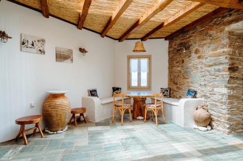 伊奥斯乔拉Heliopetra Punta的配有桌椅和石墙的房间