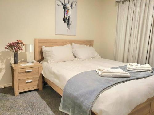 MoonahSpacious Home in West Moonah, Hobart的一间卧室设有两张床和一个带鹿图的床头柜。