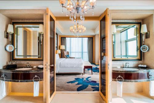 宜兴宜兴富力艾美酒店的一间带两个盥洗盆的浴室和一间带一张床的卧室